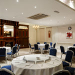 Four round tables set up for a meeting in the Cromwell Room