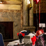 Event at The King's Hall at Mercure Leicester, The Grand Hotel, red and black napkins on a white tablecloth, red balloons