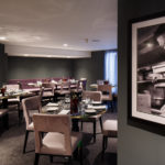 Mercure Leicester The Grand Hotel, Marco's New York Italian Restaurant, light purple seating, dark grey walls, photos of Marco Pierre White on the walls