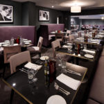 Mercure Leicester The Grand Hotel, Marco's New York Italian Restaurant, purple leather seating, dark grey walls
